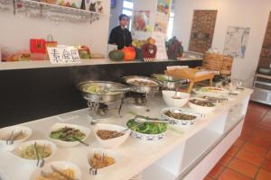 a buffet line with dishes of food on it at Vanilla Twilight in Wujie