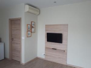 a room with a wooden floor and a white wall at Apartments Lafranconi in Bratislava