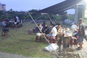 a group of people sitting at tables under a tent at Vanilla Twilight in Wujie