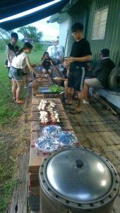 a group of people standing around a table with food at Vanilla Twilight in Wujie
