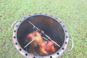 two chickens are cooking in a metal grill at Vanilla Twilight in Wujie