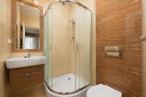 a bathroom with a shower and a sink and a toilet at Willa Daria in Władysławowo +19 photos