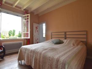 a bedroom with a bed with a white blanket at Mansion in Charrin by Loire with Pool in Charrin +32 photos