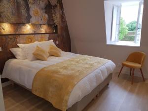 a bedroom with a large bed and a window at la blanchetière in Francueil +33 photos