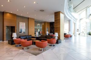 a lobby with couches and chairs in a building at Sercotel Sorolla Palace in Valencia