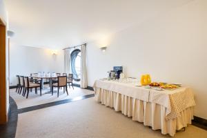 a dining room with two tables and a table with chairs at Hotel LIVVO Volcán Lanzarote in Playa Blanca