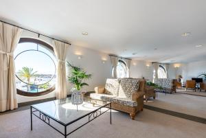a living room with a couch and a glass table at Hotel LIVVO Volcán Lanzarote in Playa Blanca