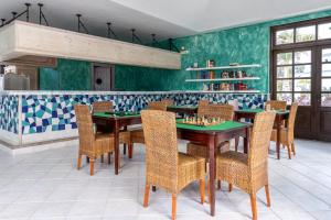 a dining room with a table with chessetts on it at Hotel LIVVO Volcán Lanzarote in Playa Blanca