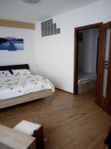 Dormitorio pequeño con cama y espejo en Apartament Daniel en Eforie Nord