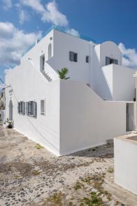 a white building with a white roof and white walls at Bedspot Hostel in Fira