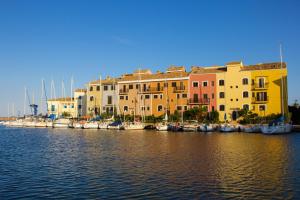 a group of buildings next to a marina with boats at Sea You Apartamentos Valencia Port Saplaya in Port Saplaya