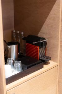 a coffee maker sitting on top of a cabinet at OMM INN in Eskisehir