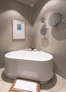 a large white bath tub in a room at OMM INN in Eskisehir