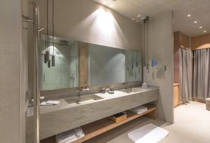 a bathroom with two sinks and a large mirror at OMM INN in Eskisehir