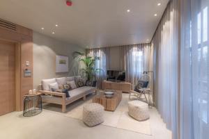 a living room with a couch and a tv at OMM INN in Eskisehir