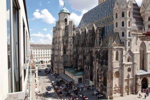 Une grande cathédrale avec une foule de gens devant elle dans l'établissement Pension Sacher - Apartments am Stephansplatz, à Vienne