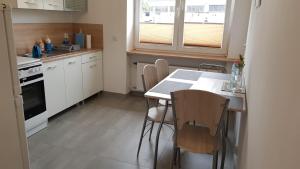 a kitchen with a table and chairs in it at de Gaulle'a 20 in Zabrze