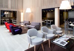 a waiting room with chairs and tables and a table at Libertel Gare de L'Est Francais in Paris