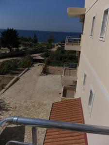 a balcony of a building with a view of the ocean at Hotel Afrodite in Dhërmi