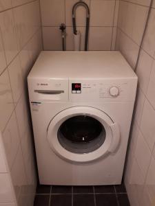 Waschmaschine und Trockner in einem kleinen Zimmer in der Unterkunft Stuga Bra Nock in Brösarp