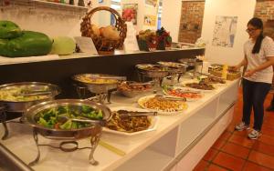 a woman standing in front of a buffet of food at Vanilla Twilight in Wujie
