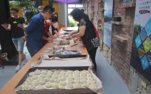 a group of people standing around a table preparing food at Vanilla Twilight in Wujie