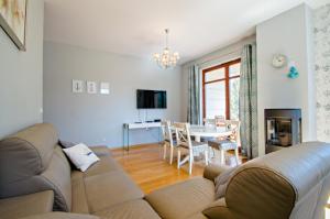 a living room with a couch and a table at Grand Apartments - Deluxe Apartment with Balcony in Gdańsk