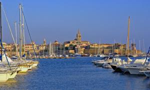 a bunch of boats are docked in a marina at SMERALDA in Alghero