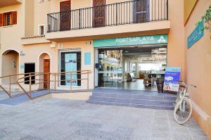 a bike parked in front of a store at Sea You Apartamentos Valencia Port Saplaya in Port Saplaya