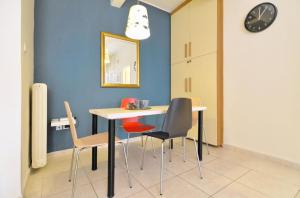 a dining room with a table and chairs at Courtyard Apt - Central Athens in Athens