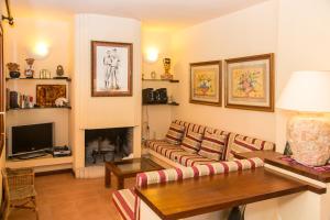 a living room with a couch and a fireplace at Sa Rondalla - Formentera in Playa Migjorn