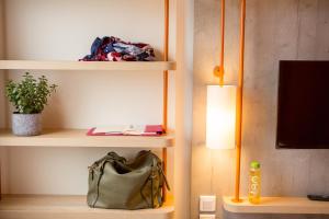 a purse sitting on a shelf next to a lamp at ibis budget Cherbourg - La Glacerie in Cherbourg en Cotentin