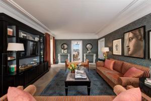a living room with a couch and a table at Rocco Forte Hotel De La Ville in Rome