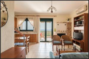 a kitchen and living room with a view of the ocean at Oxana house in Nea Moudania