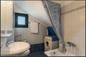 a bathroom with a sink and a toilet and a shower at Oxana house in Nea Moudania +16 photos