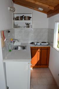 a kitchen with a sink and a counter top at Theodore Apartments in Zakharo