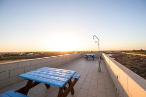 a blue bench sitting on top of a roof at El Caseron de Conil & Spa in Conil de la Frontera