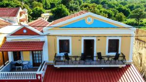 a house with a deck with chairs on it at Korali in Symi