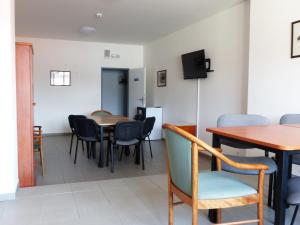 a dining room with tables and chairs and a tv at Ubytovani Rico in Vrchlabí