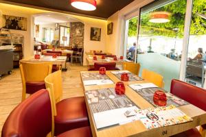 a restaurant with tables and chairs and a window at Auberge du Bon Vivant in Argelès-sur-Mer