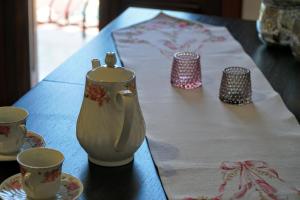 a table with a tea pot and cups on it at Korali in Symi