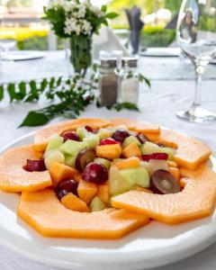 a plate of fruit and vegetables on a table at Oasis Hotel in Gaborone +31 photos