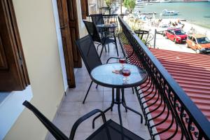 a table with two glasses of wine on a balcony at Korali in Symi