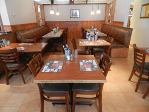 a dining room with wooden tables and chairs at Maison Chez Laurent in Baie-Saint-Paul