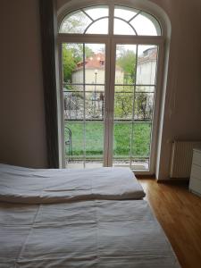 a bed in a room with a large window at Apartament Trzy Korony 1 in Świnoujście