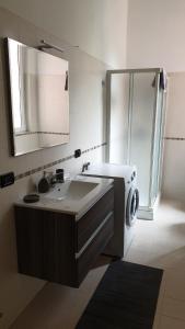 a bathroom with a sink and a washing machine at cesena3 plus in Milan