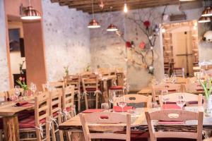 a dining room with wooden tables and chairs at Locanda Ponte Serra in Lamon +29 photos