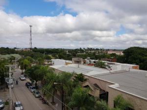 arial view of a city street with palm trees at Departamenos Llanos in Termas de Río Hondo