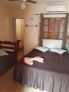 a bedroom with two beds and a window at Hotel Nove De Julho in Marília