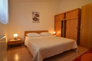 a bedroom with a bed and two lamps on tables at Big Dream 2 in Rovinj